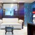 Amrit Villa, New Delhi lobby with white sofa, coffee tables, wall mirror and brochure stand