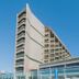 Hotel Sete Coqueiros in Maceió with modern white facade and glass balcony under clear blue sky