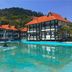Sari Pacifica Resort & Spa, Redang Island: resort villas beside a turquoise pool with mountain backdrop.