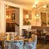 The White Horse, Dorking lounge with patterned chairs, dining tables, lamps and warm interior lighting
