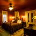Swantown Inn & Spa in Olympia bedroom with wrought-iron bed, warm lighting, dresser and armoire