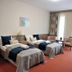 Hotel Három Gúnár in Kecskemét: twin beds in a guest room with red carpet and balcony doors