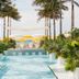Palm Heights in North Side: tropical pool deck with palm trees, cabanas and ocean view