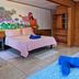 Keuhenua Hostal in Hanga Roa spa room with three massage beds and colorful wall mural