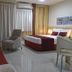 Bourbon Vitoria Residence Hotel room in Vitória with bed, sofa, TV, and lounge chair