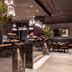 Worldhotel Cristoforo Colombo Milan buffet restaurant with dark wood decor and hanging glass lights