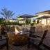 Hilton Garden Inn Riverhead outdoor fire pit with seating and patio dining at dusk