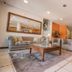 Ilha Flat Hotel in Ilhabela lobby with sofas, coffee table, staircase and mirror wall decor