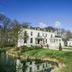 Fletcher Hotel Landgoed Huis te Eerbeek in Eerbeek beside a pond with landscaped gardens and white facade