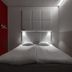 Omena Hotel Tampere room with twin beds, red accent wall, and minimalist wall paneling in Tampere