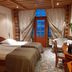 Power Park Accommodation in Kauhava: cozy twin room with wooden ceiling and balcony door