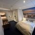 Sea You Hotel Noordwijk room with double bed and large beach scene wall mural in Noordwijk