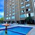 SJ Tour - San Juan Foz do Iguaçu poolside view with outdoor pool and hotel tower in Foz do Iguaçu