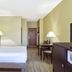 Country Inn & Suites by Radisson, Benton Harbor-St guest room with king bed, desk, lamps, and TV