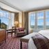 The Ugadale Hotel in Campbeltown room with sea view, large windows, bed, chair and desk