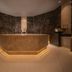 Hotel Zurserhof in Zürs spa area with central stone basin and warm ambient lighting