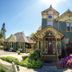 Swantown Inn & Spa in Olympia with Victorian exterior, garden path, and bright flower beds