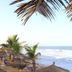 The Kairaba Beach Hotel in Serrekunda with palm trees overlooking a sandy beach and ocean waves