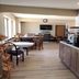 Super 8 by Wyndham Estherville breakfast area with tables, chairs and coffee station