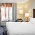 Fairfield Inn & Suites by Marriott Paducah guest room with bed, desk, chair, and window with curtains