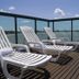 Bourbon Vitoria Residence Hotel in Vitória with lounge chairs on a deck overlooking the water