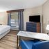 Candlewood Suites Topeka West By IHG guest room with king bed, TV, and window air conditioner in Topeka
