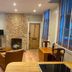 The Old Railway Station Petworth lounge with brick fireplace, leather chairs, and wood windows