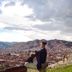 Rumi Wasi in Cusco with city and mountain views beside a historic tower