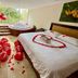 Hotel San Pedro del Fuerte in Medellín, room with bed decorated in rose petals and balloons beside a hot tub