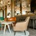 Motel One München-Westend lounge in Munich with colorful chairs, tables and a stylish bar area