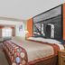 Super 8 by Wyndham Port Royal/Beaufort guest room with king bed, TV, and window seating area