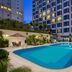 Millennium Hotel Sirih Jakarta outdoor pool terrace in Jakarta with loungers and high-rise view