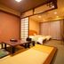 Motoyu No Yado Kurodaya in Beppu room with tatami seating area and bed beside sliding curtains