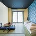 Tabist Sparkling Dolphins Inn Kyoto room with tatami mats, low table, futons and a window view in Kyoto