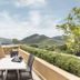 Soho Hotel & Casino at Sun City Resort terrace with table, chairs and mountain view