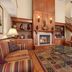 Country Inn & Suites by Radisson, Doswell, VA lobby with fireplace, staircase, and seating area
