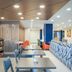Holiday Inn Express & Suites Nampa - Idaho Center lobby seating area with tables, sofa, and TV