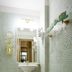 Ekesparre Boutique Hotel Kuressaare bathroom with mosaic tile walls, pedestal sink and gold accents