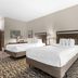 Best Western Plus McDonough Inn & Suites room with two beds and neutral decor in McDonough