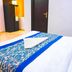 Hotel Ashoka Palace Near Igi Airport, New Delhi guest room with neatly made bed and chair