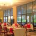 The Kairaba Beach Hotel in Serrekunda with a bright dining room and large windows overlooking greenery
