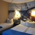 Zur Fichtenbreite in Klieken: twin beds in a nautical-themed guest room with wall mural