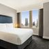 Hilton Motif Seattle guest room with king bed and city skyline views