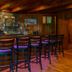 The Lodge on Lake Lure bar with stone wall, wood counter and stools in Lake Lure