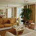 Palm Heights North Side living room with ocean view, beige seating, coffee table, and floor-to-ceiling windows
