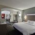 Quality Inn & Suites Irving Dfw Airport South room with king bed, seating area, and TV in Irving