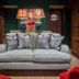 Cotswold Plough Hotel & Restaurant in Bampton lounge with gray sofa, lamps and green walls
