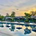 Ibis Styles Sepang Klia poolside resort view at sunset with loungers and reflected umbrellas in Sepang