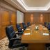 Meeting room at Millennium Hotel Sirih Jakarta in Jakarta with a long conference table and leather chairs