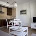 Apartamentos Vista Real in La Línea de la Concepción: apartment with kitchenette, dining table and TV area